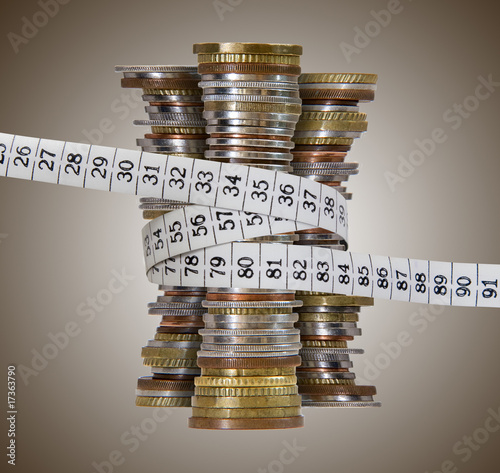 coin towers with measure tape, brown background