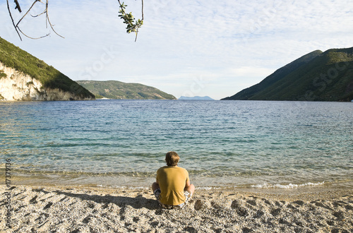 man sitting alone on beach. photo