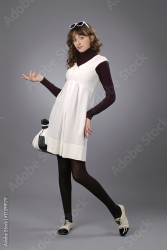 Model girl posing in studio on grey background