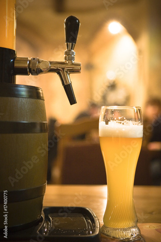 glass of beer with foam and beer butt