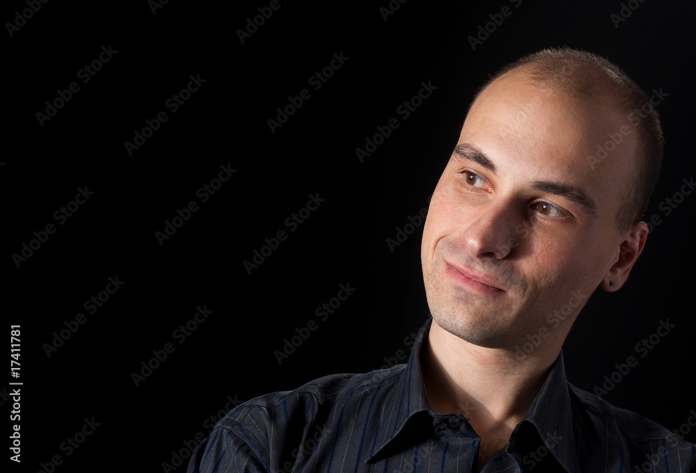 Portrait of a handsome young man smiling. Isolated on black back Portrait of a handsome young man smiling. Isolated on black back