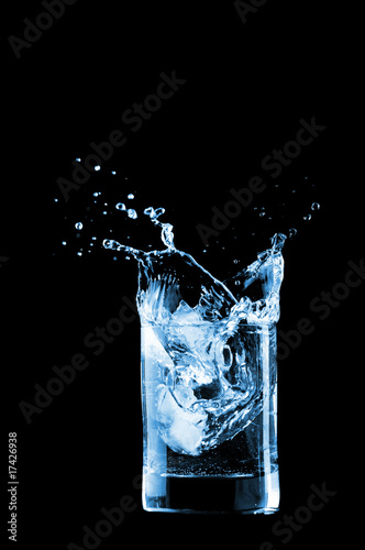 Water in glass isolated on black background