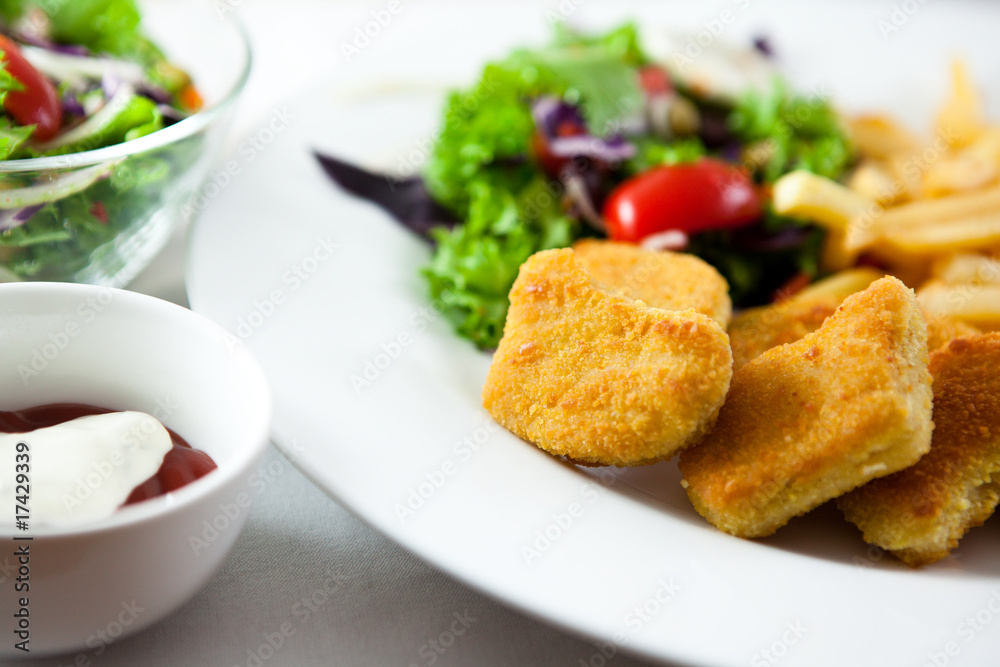 Breadcrumbed chicken with french fries and salad