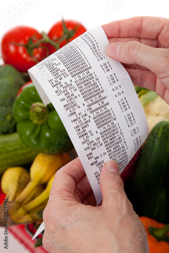 Grocery receipt over a bag of vegetables