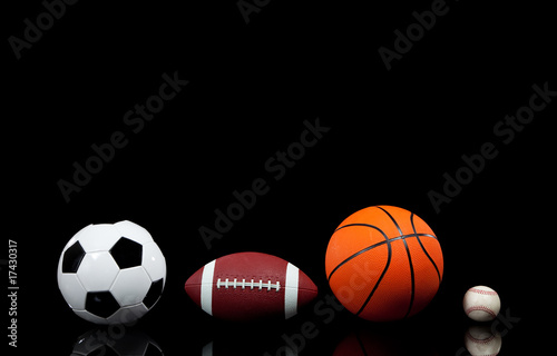 Sports balls on a black background