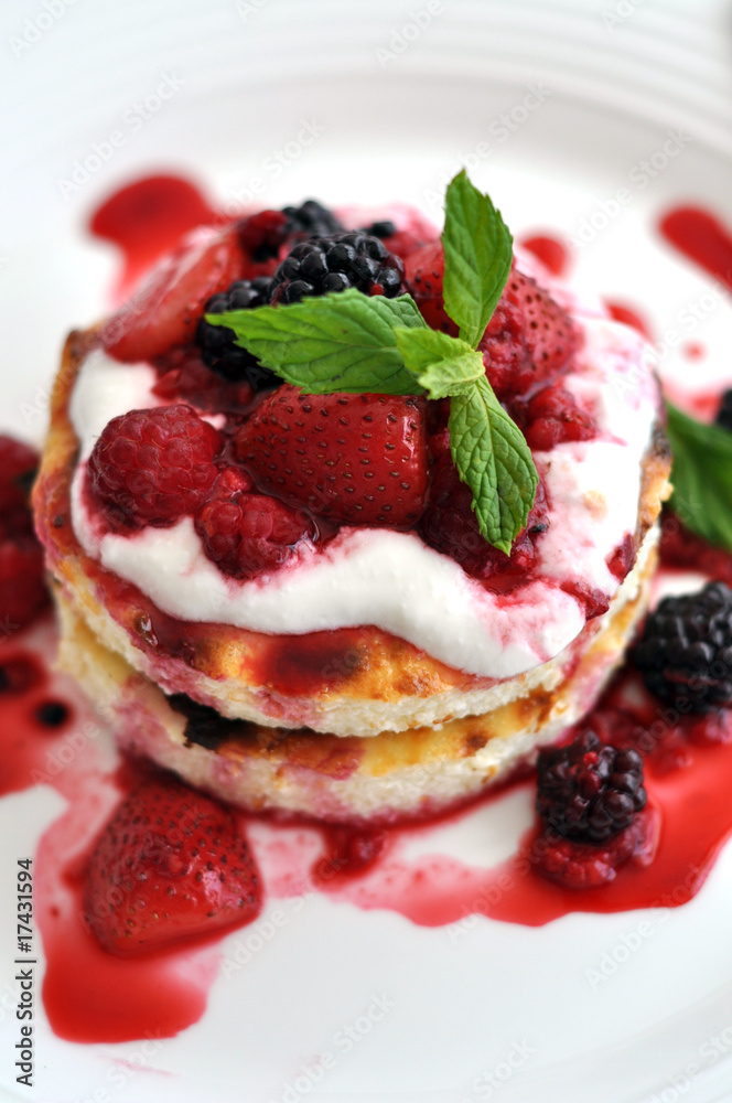 Individual cheesecake with summer berries on the plate. Individual cheesecake with summer berries on the plate.