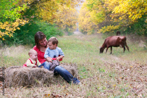 happy mother with two children in autumn park