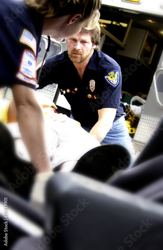 EMTs helping victim from car crash photo