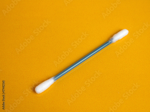 Cotton stick on yellow background