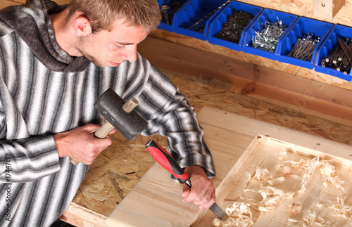 Young carpenter at work in a workroom