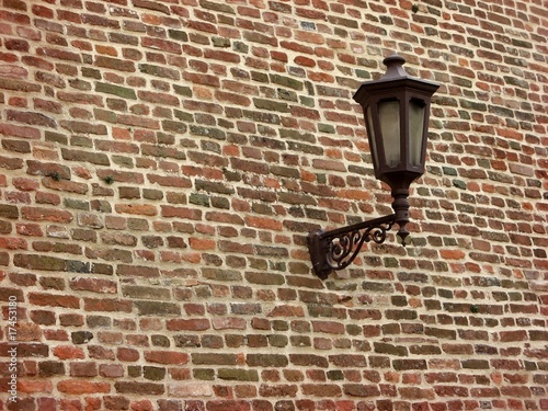 Lantern. Brick wall detail.