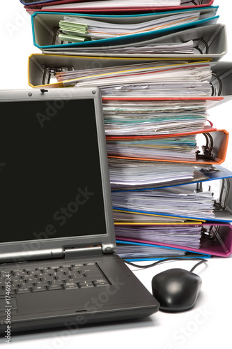 Isolated stack of folders with laptop computer