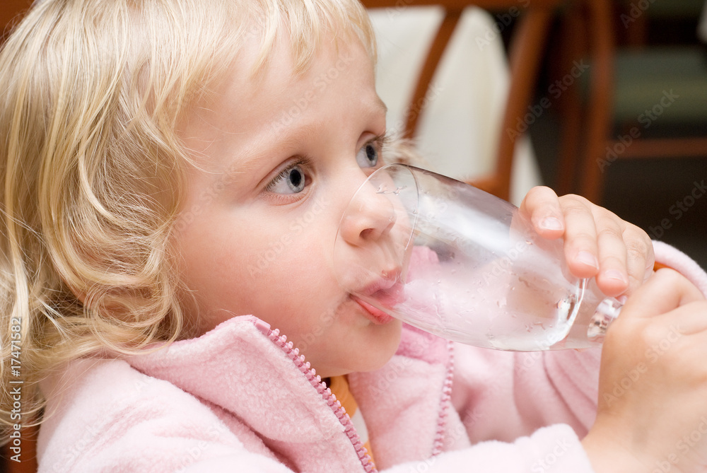 Little girl drinking water in a restaurant Little girl drinking water in a restaurant