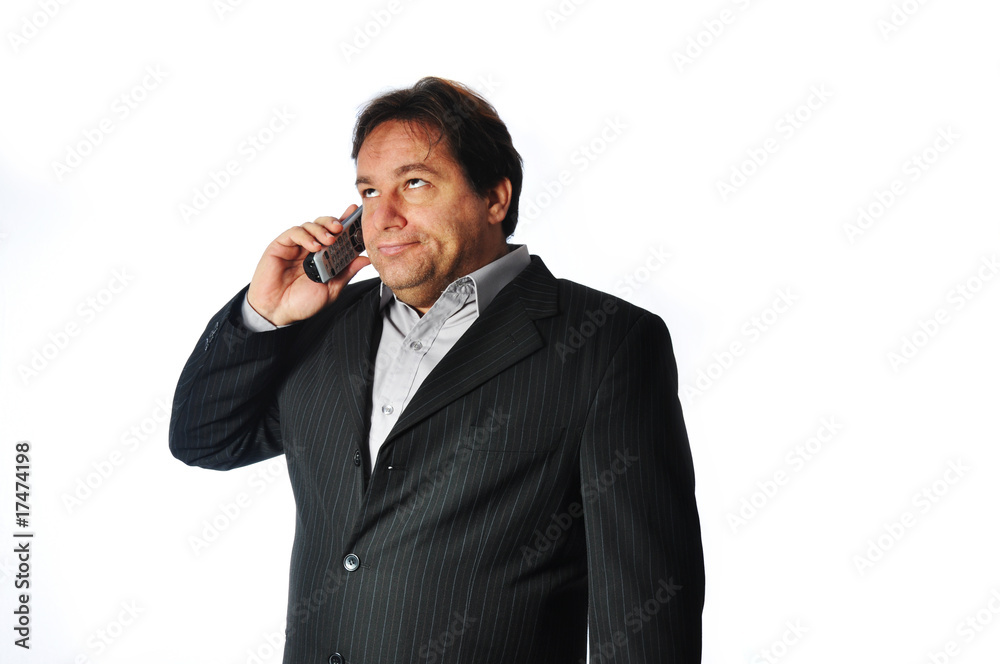Studio Shot of Business Man irritated and impatient on the phone Studio Shot of Business Man irritated and impatient on the phone