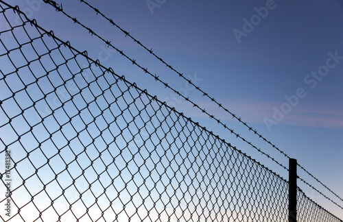 Chain link fence and barbed wire photo