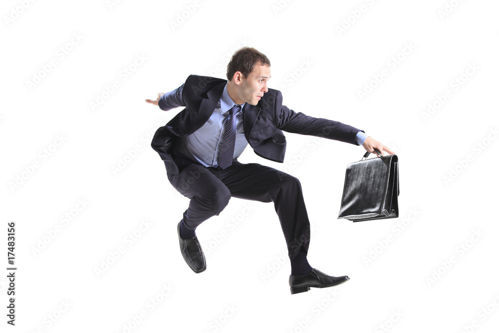 Young businessman with a briefcase jumping Young businessman with a briefcase jumping