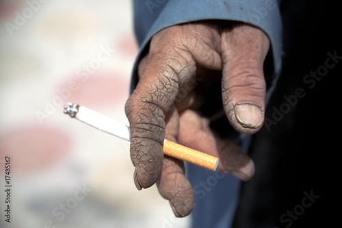 close up shot of hand holding cigarette