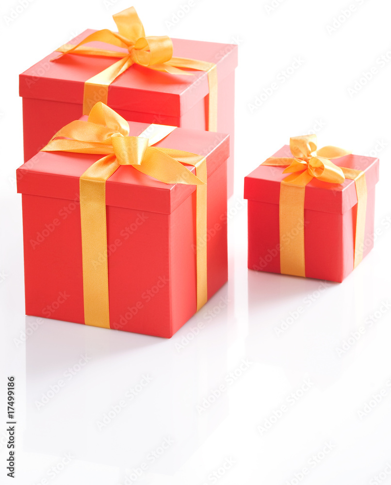 Various sizes red gift boxes with gold ribbon. Various sizes red gift boxes with gold ribbon.
