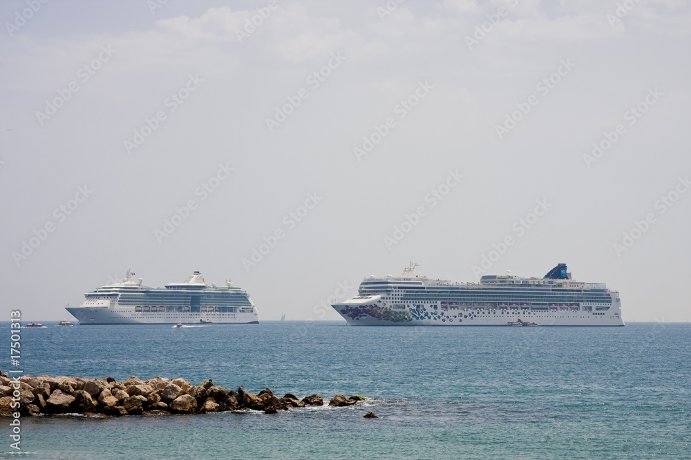Two Cruise Ships Past Rocks