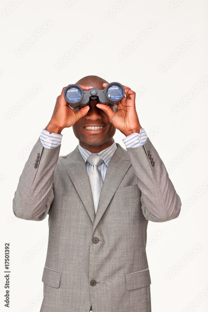 Afro-American businessman looking through binoculars Afro-American businessman looking through binoculars