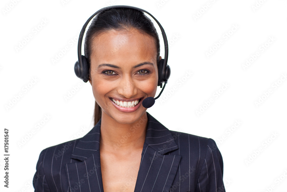 Beautiful ethnic businesswoman with a headset on smiling at the Beautiful ethnic businesswoman with a headset on smiling at the