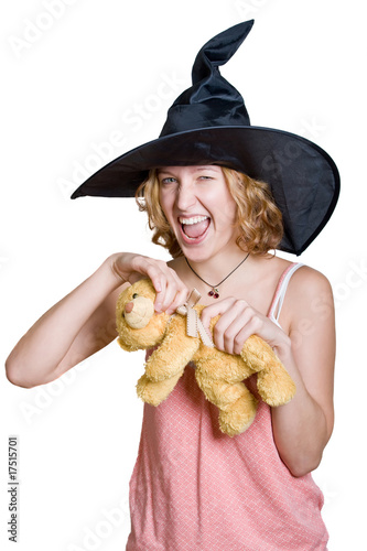 Witch girl in a halloween black hat with teddy bear