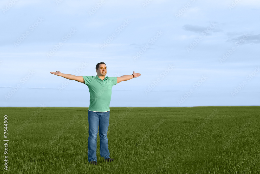 man take energy from nature in the meadow with dark blue sky man take energy from nature in the meadow with dark blue sky