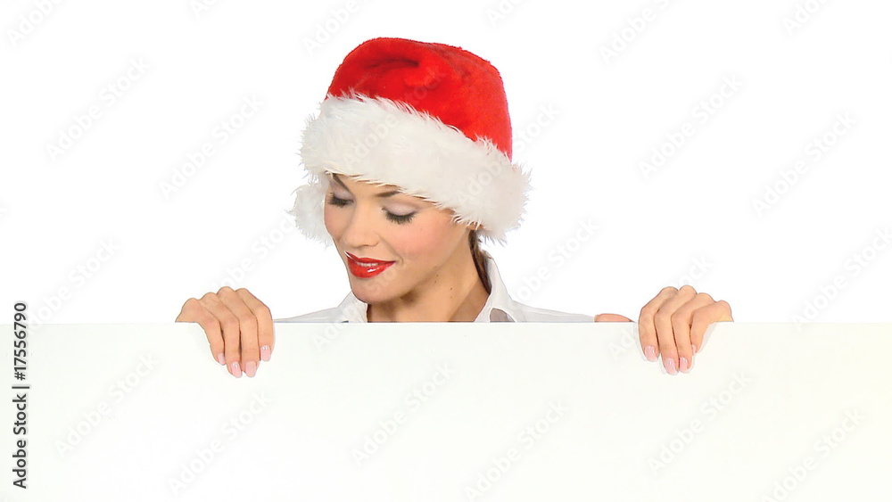 Girl in santa claus hat holding empty board Girl in santa claus hat holding empty board