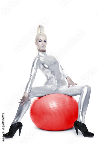 Beautiful cyber woman sitting on a red ball