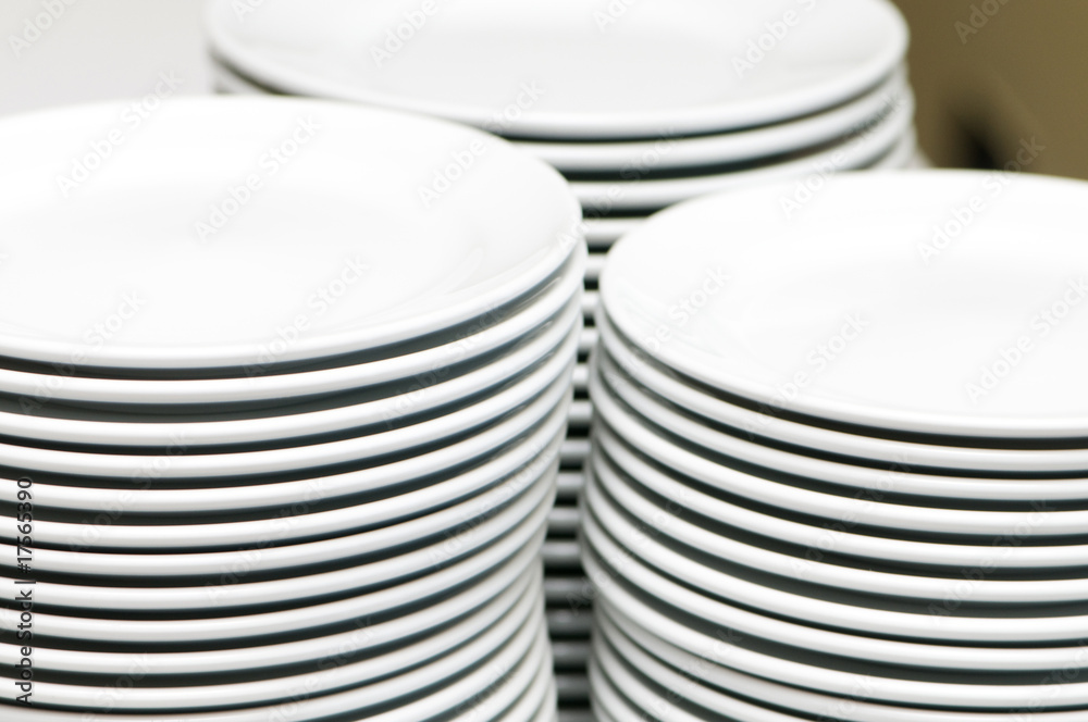 Stacks of empty white plates Stacks of empty white plates