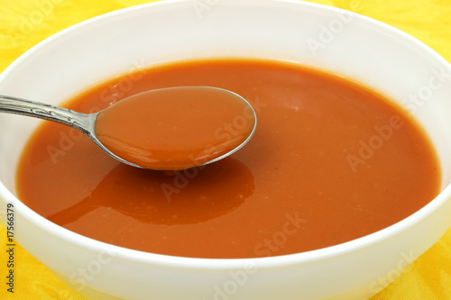 Obraz na plátně Serving of tomato soup in a white bowl