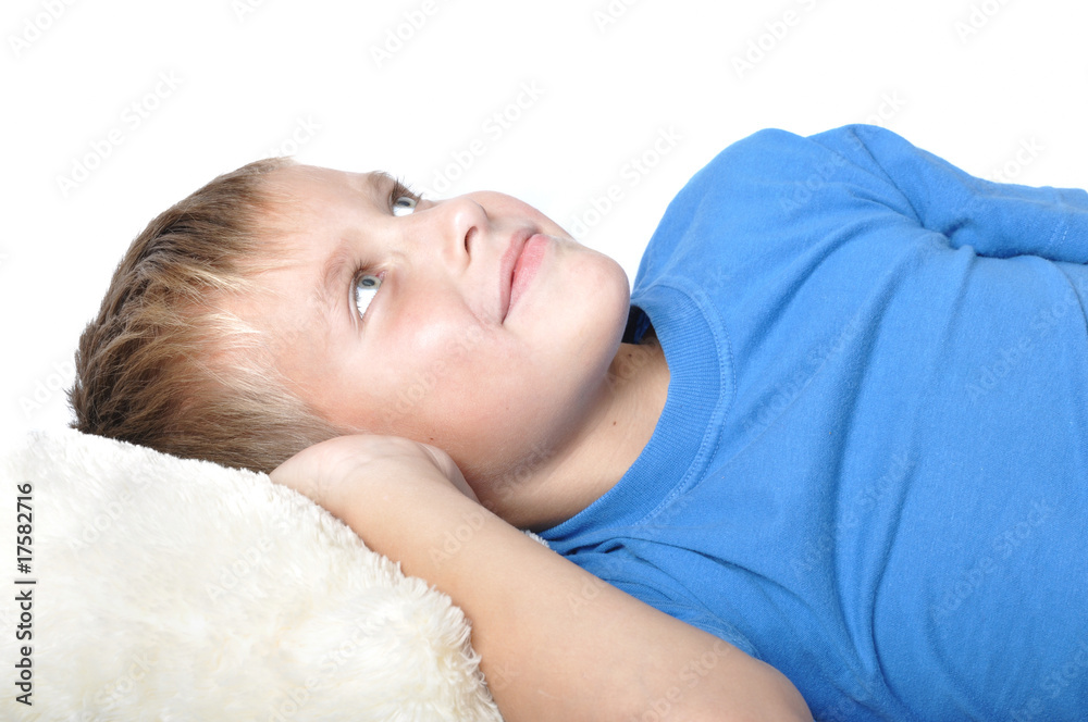 boy rests upon pillow boy rests upon pillow