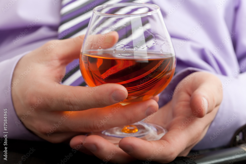 Hand with glass of cognac Hand with glass of cognac