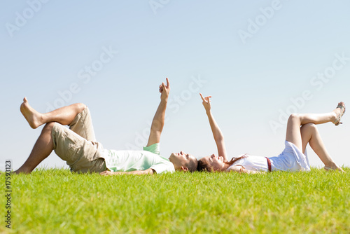 couple lie down on grass