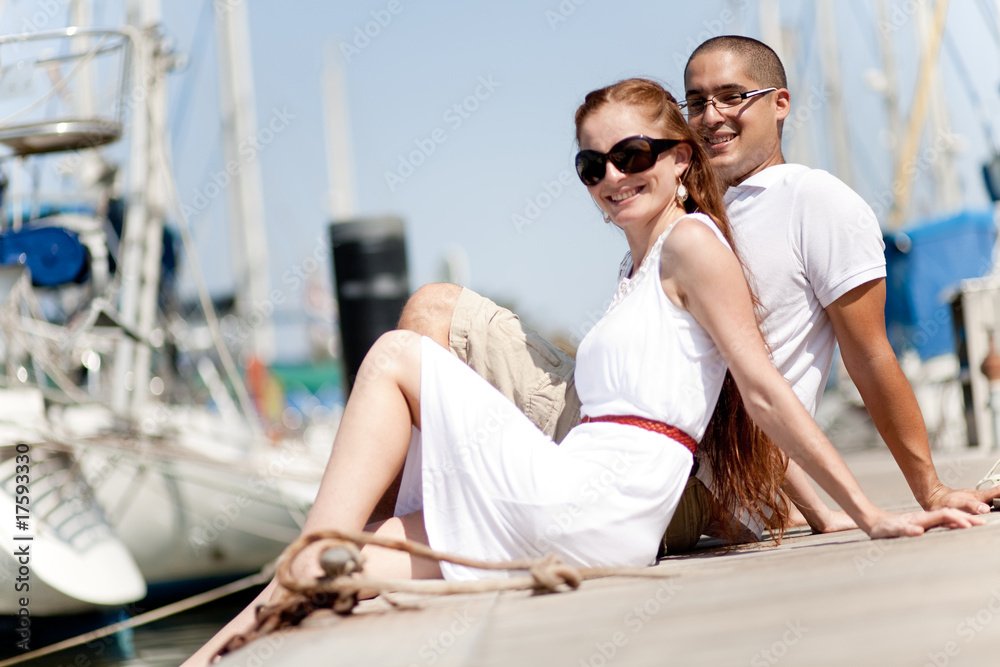 Young Couple Seated and Hugging On A Footbridge