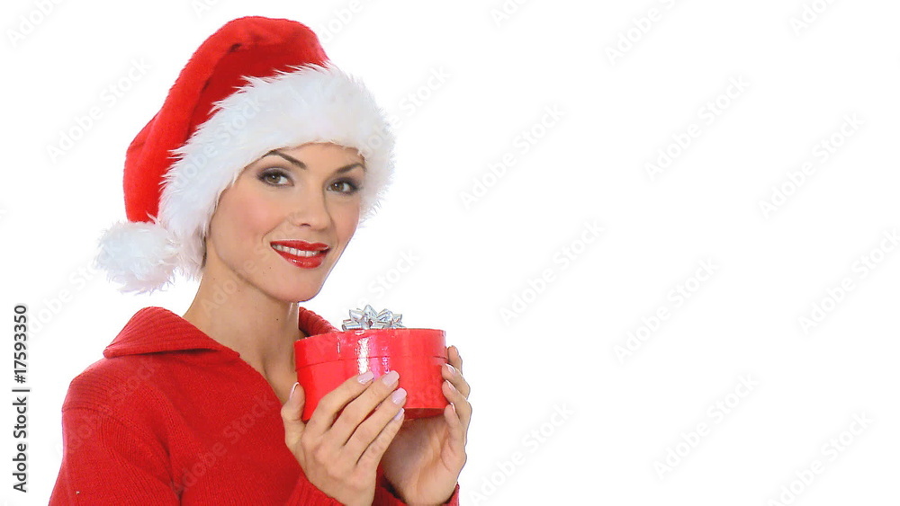 Sexy girl in santa claus hat showing a gift in box Sexy girl in santa claus hat showing a gift in box
