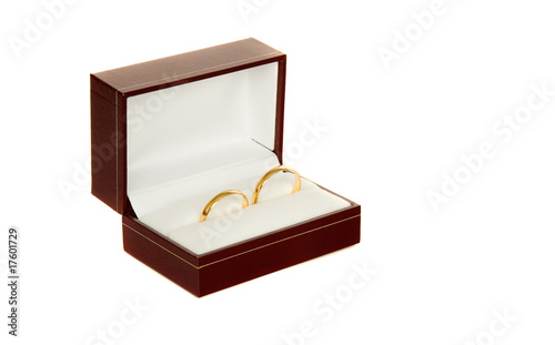 Two golden wedding rings in a box isolated on white