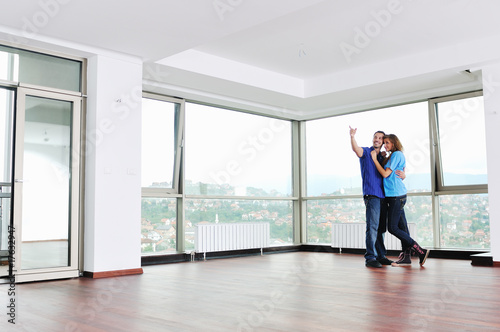 happy couple in empty apartment