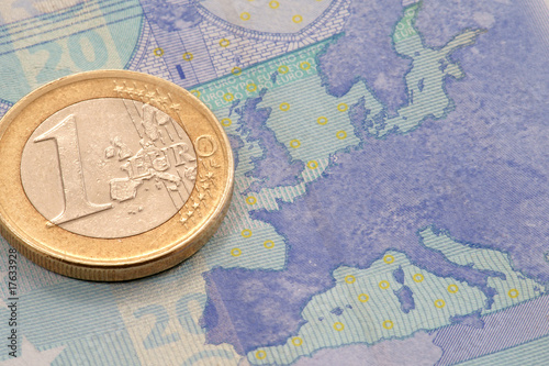 Euro coin on euro banknote