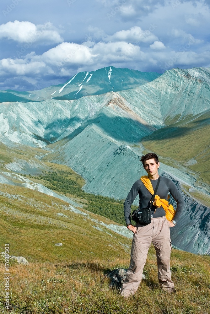 young man stanging on a mountain top young man stanging on a mountain top