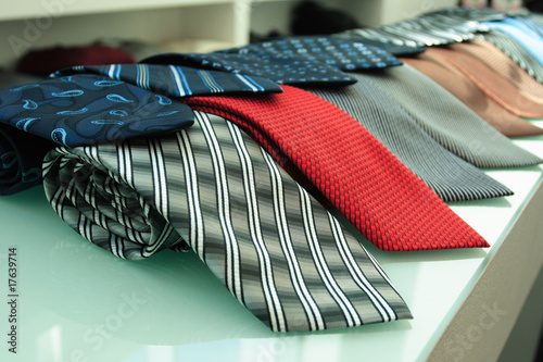 Photo Red gray blue and others  necktie  on shelf