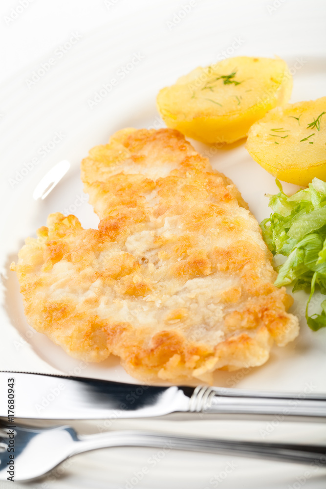 Fish dish - fried fish fillet with potatoes and vegetables