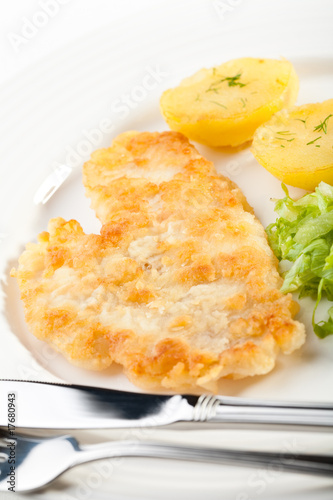 Fish dish - fried fish fillet with potatoes and vegetables