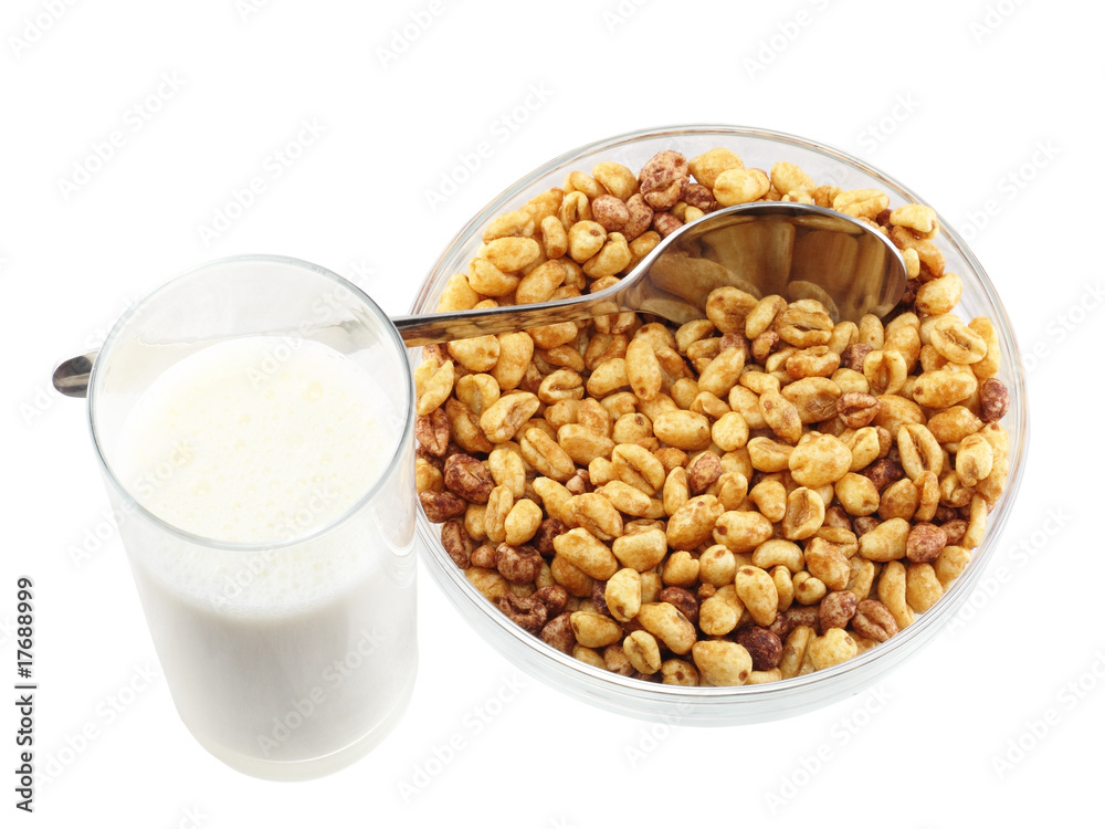 Glass bowl of cold cereal flakes,glass of milk . Isolated