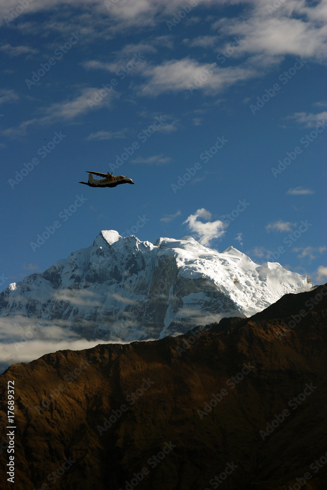 Airplane over the snow-capped mountains Airplane over the snow-capped mountains