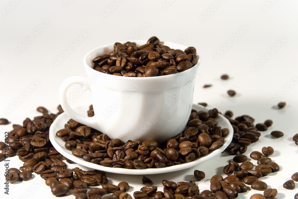 White cup with coffee beans White cup with coffee beans