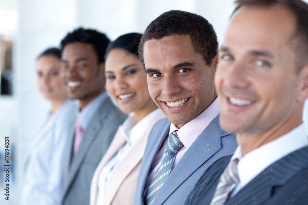Attractive businessman in a row with his team Attractive businessman in a row with his team