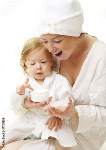 picture of happy mother with baby holding cosmetic cream
