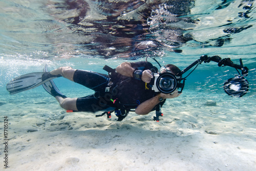 An underwater photographer in shallow water.