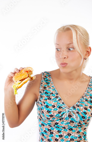 Surprised girl eating burger